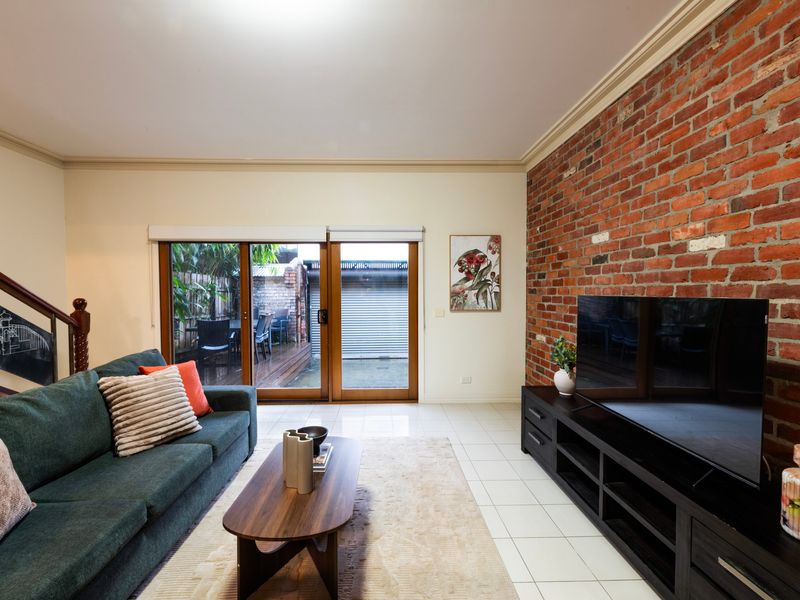 Indoor-Outdoor Flow: Bright entertainment space with durable tiled floors and seamless courtyard access.