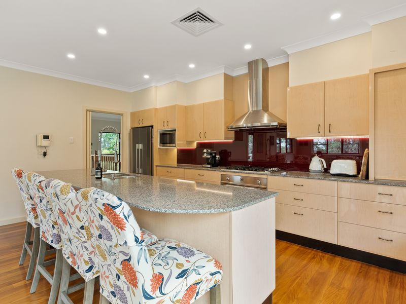 Bright lights and colorful chairs make this kitchen a delightful space.