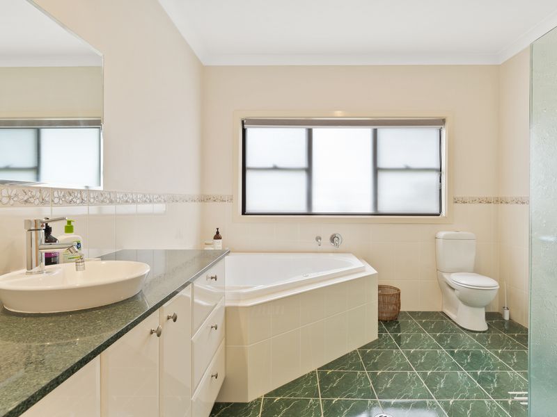Bathroom with a relaxing bath and spacious shower.