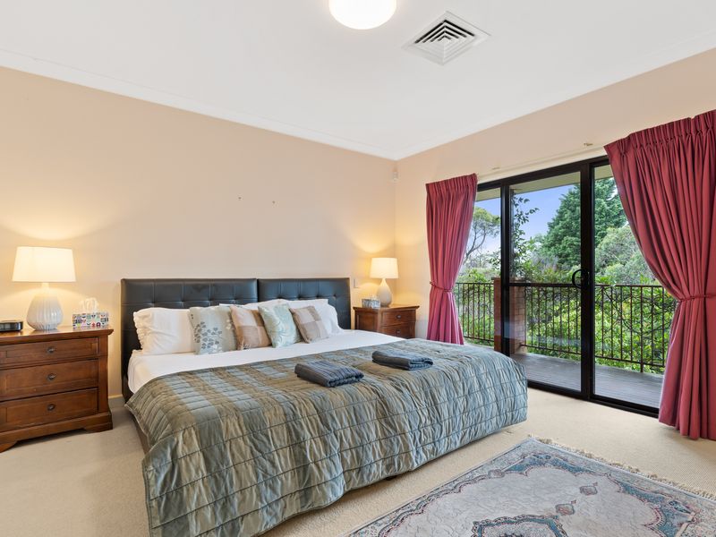 Relax in this spacious bedroom with a comfy bed and private balcony access overlooking the beautiful greenery.