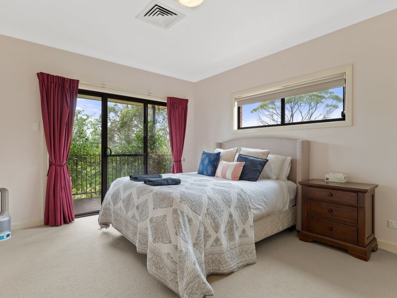 A cozy and inviting bedroom with beautiful views and natural light, perfect for a restful stay.