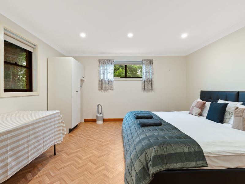 Bright and airy room with a large bed and tasteful decor.