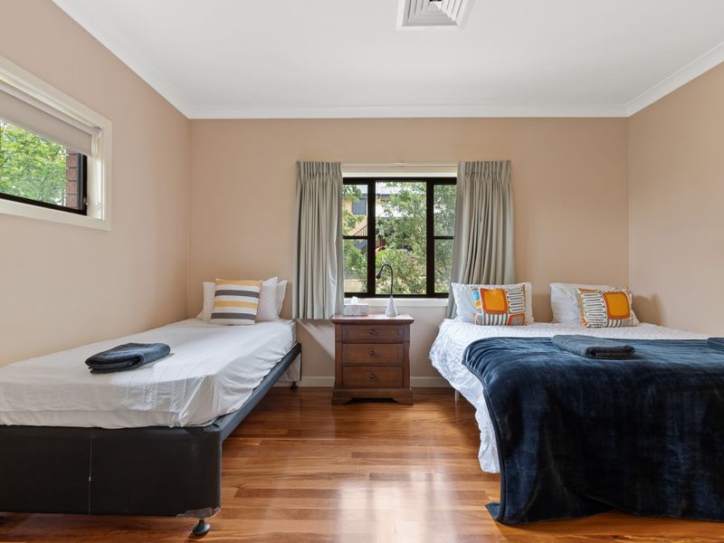 Bright and airy bedroom with two comfortable beds, perfect for a relaxing stay.