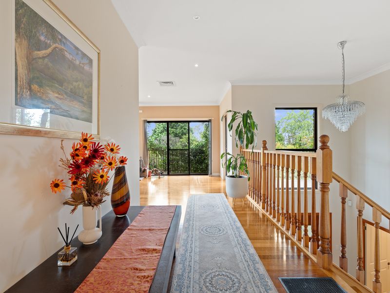 Elegant hallway featuring a striking chandelier and vibrant decor.