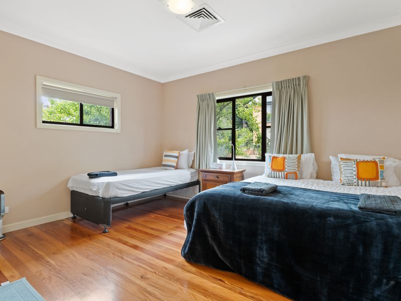 A cozy bedroom with two comfortable beds, offering a peaceful retreat and natural light.