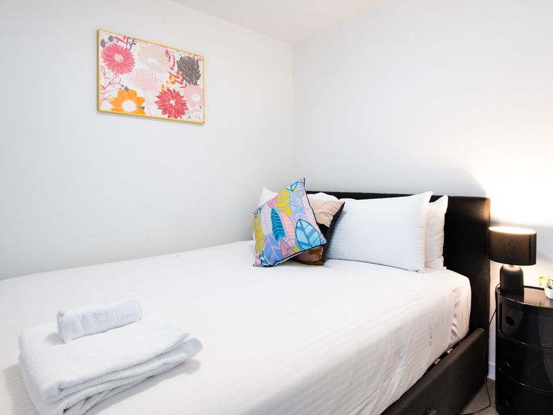 The second bedroom features a comfortable queen-sized bed, providing ample space for a restful night’s sleep.