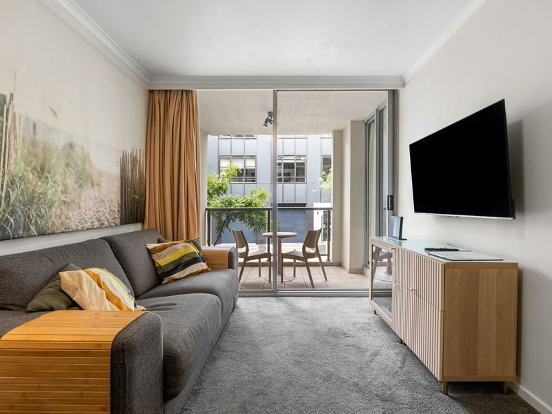 Cozy Lounge with Balcony Views – Unwind on the comfortable couch while watching TV or stepping out for fresh air.