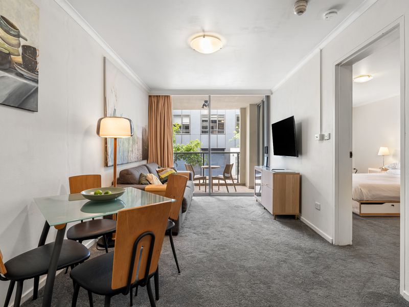 Bright & Airy Living Area – Enjoy natural light and an open layout leading to a private balcony with outdoor seating.