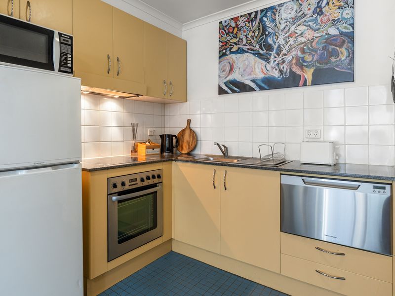 Fully Equipped Kitchen & Dining – Prepare home-cooked meals with all essentials at hand and dine at the sleek glass-top table.