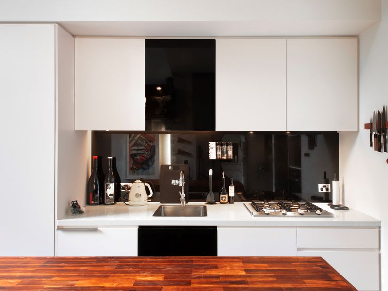 Prepare meals in this beautifully designed, modern kitchen with sleek lines and high-end finishes.