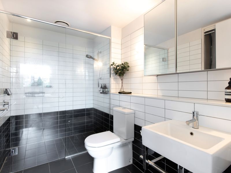 Modern and sleek, the bathroom features a spacious shower and toilet, offering all the essentials for your stay.