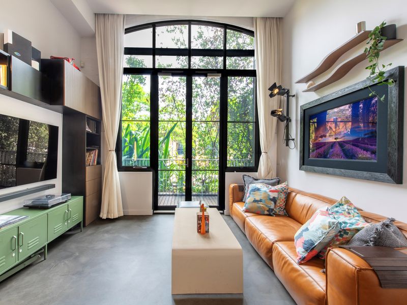 Relax in style on the comfy couch in this cozy living space, where art meets comfort.