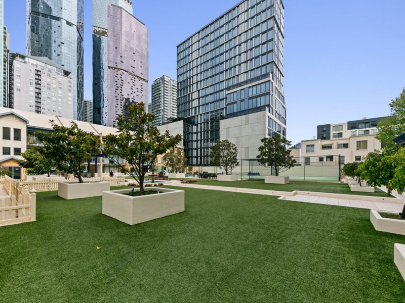Landscaped communal courtyard with green spaces and seating areas.