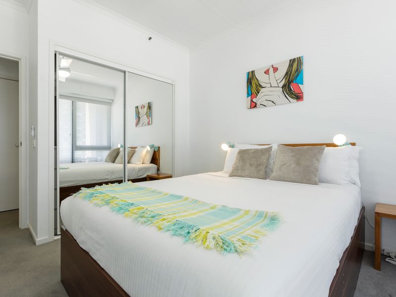 Second bedroom with double bed, ceiling fan and neutral styling for a restful stay.