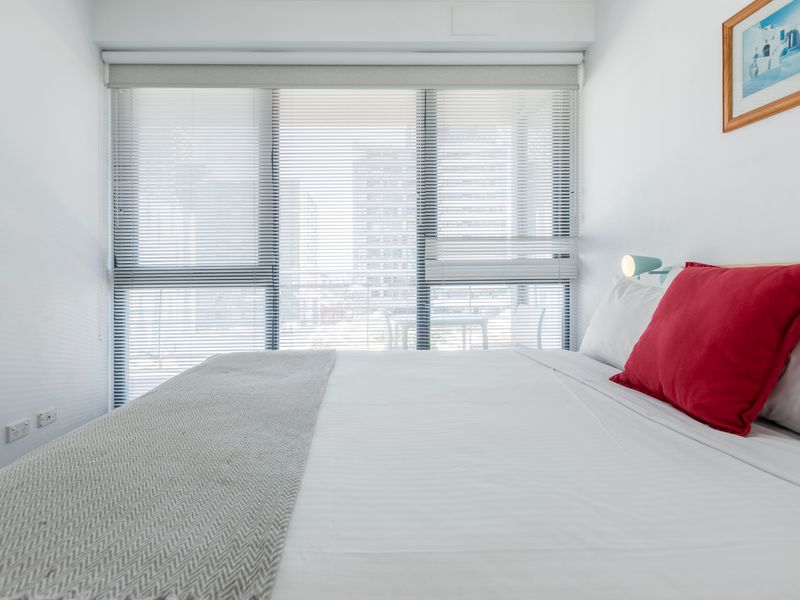 Another perspective of the first bedroom highlighting the airy layout and natural light.