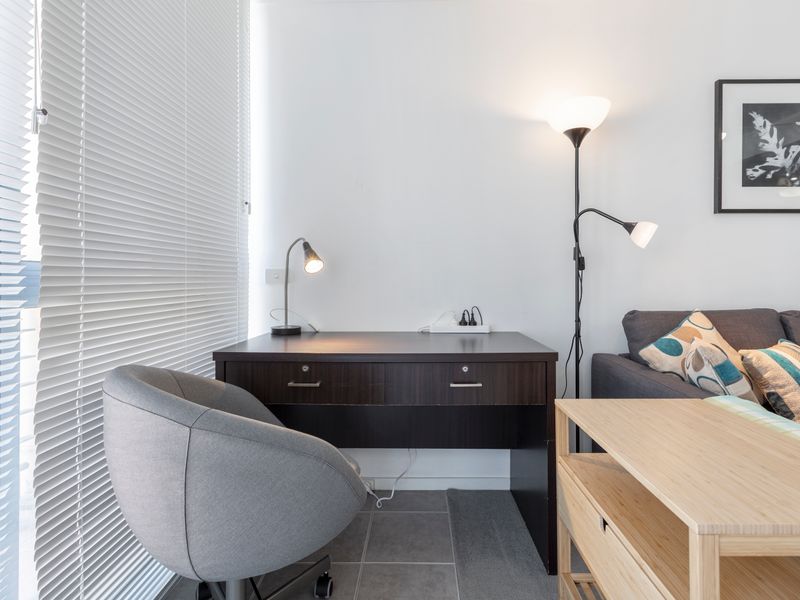 Dedicated workspace with desk and chair positioned beside a window, perfect for remote work or study.