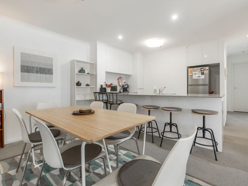 Open plan kitchen and dining space with modern appliances and a generous dining table for shared meals.