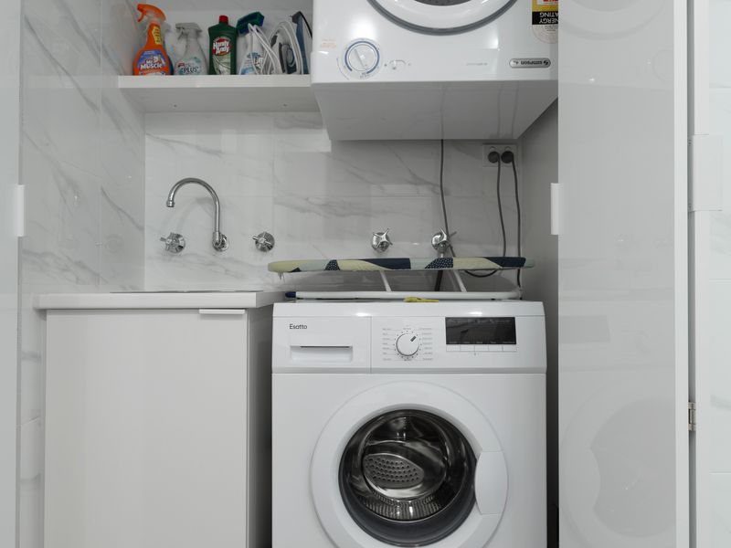 Separate laundry area with washing machine, dyer and sink for added convenience during longer stays.