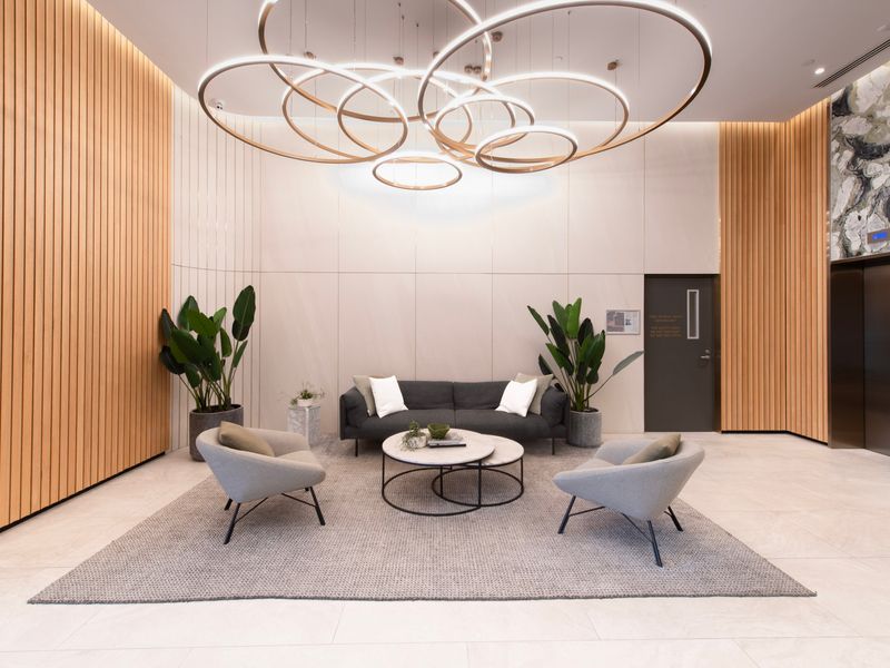 Stylish building lobby with modern décor and welcoming seating.