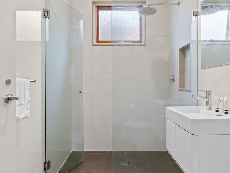 Bright and airy bathroom with a sleek, modern shower.