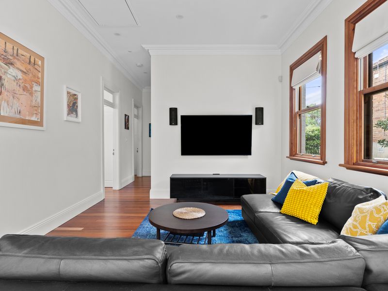 Enjoy your favorite shows on the large TV in this stylish space.