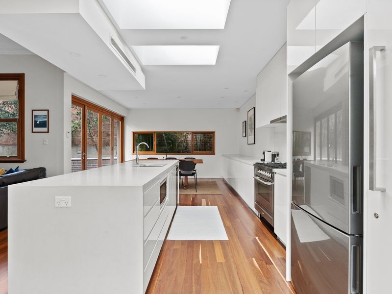 Charming Outdoor Space – Step outside to the private courtyard with lush greenery for a moment of tranquility.