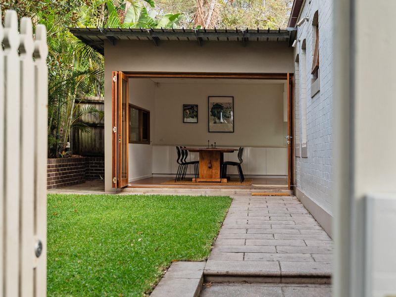 Stylish dining and kitchen area with natural light pouring in, creating a warm and welcoming atmosphere.