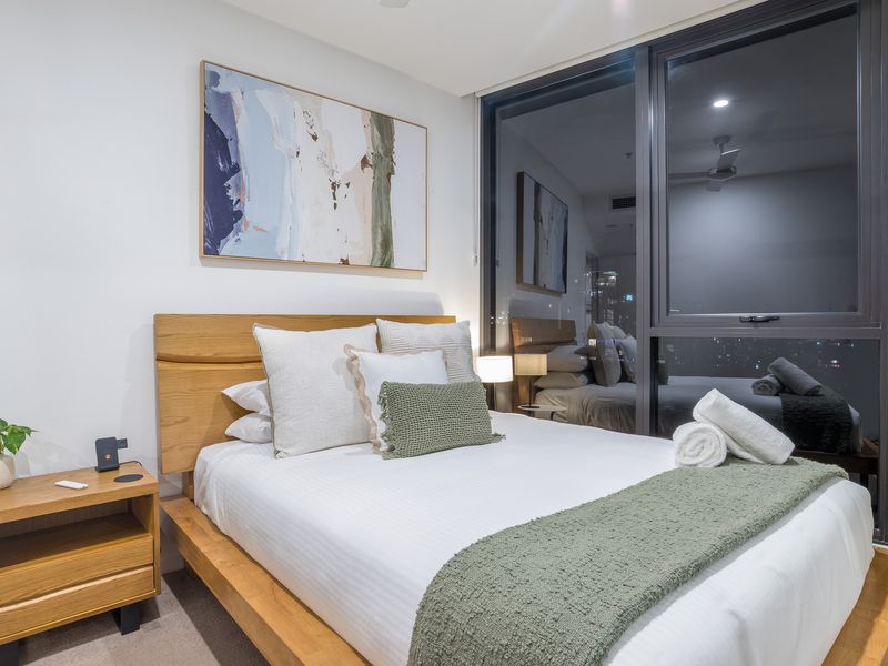 Drift off to sleep in style and serenity! Our second bedroom is a haven of modern comfort, featuring a cozy bed framed by a warm natural timber headboard.