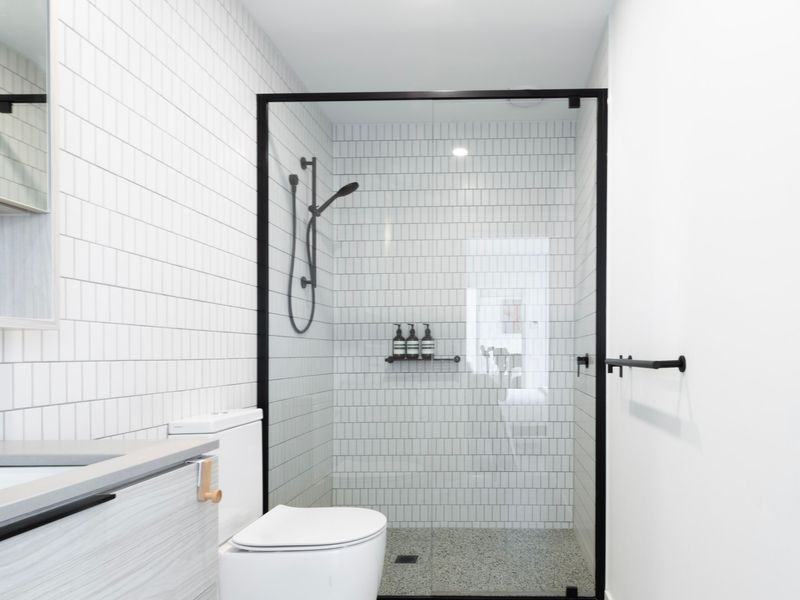 Contemporary ensuite bathroom with walk-in shower and minimalist finishes.