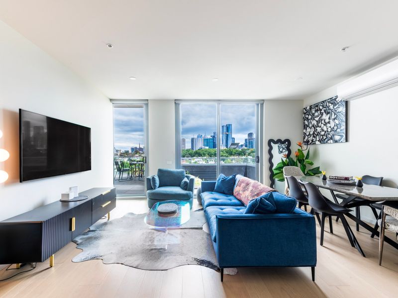 Bright and modern living area with floor-to-ceiling windows and city views.