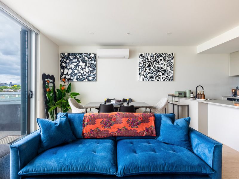 Spacious open-plan lounge with vibrant accents and natural light.