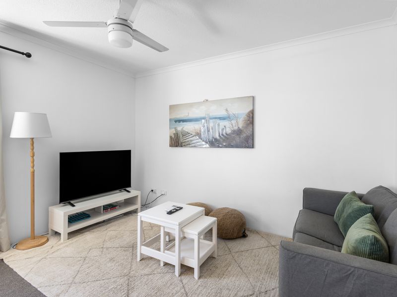 Bright and comfortable living space featuring a lounge area perfect for watching TV.