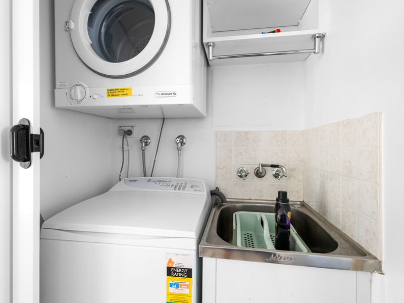 In-unit laundry convenience. This dedicated wash service area provides a full-sized washing machine and a clothes dryer (stacked), along with a laundry tub for any hand-washing needs.