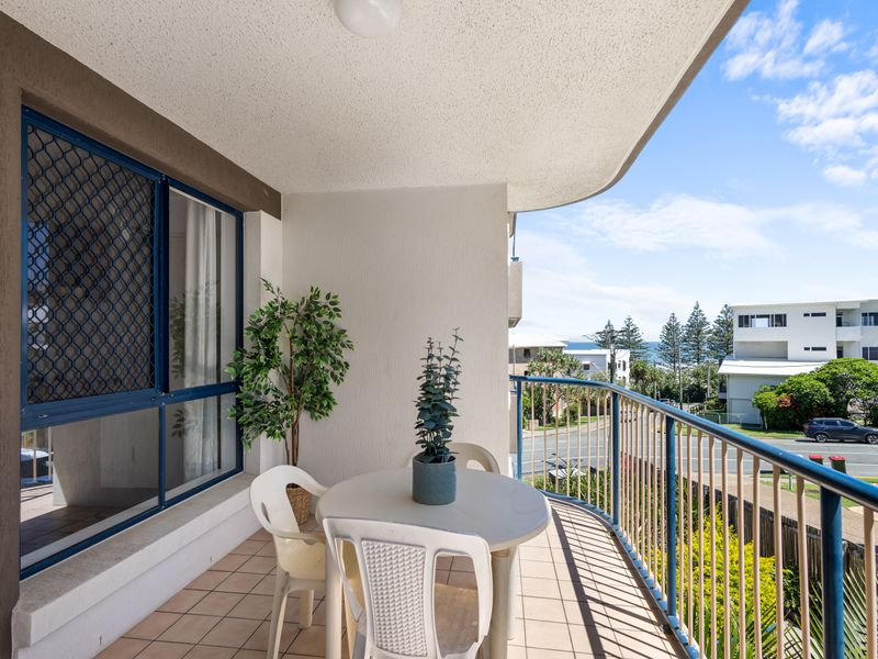 Your private balcony offers a relaxing space with an outdoor dining table and seating to enjoy the fresh coastal air. Look out over the immediate surrounding streets and catch glimpses of the nearby ocean and neighborhood.