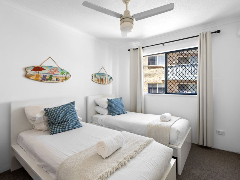 This room is set up for flexible sleeping arrangements, featuring two comfortable beds.