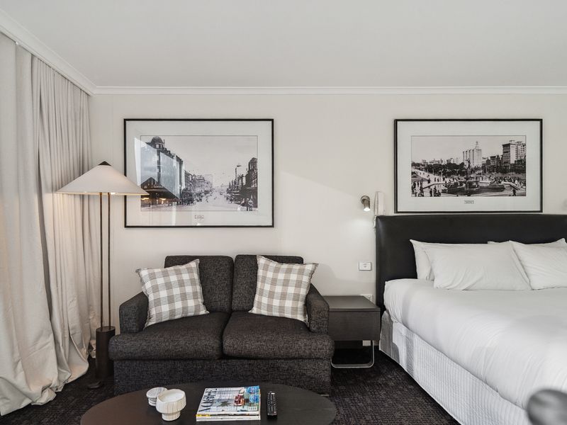 Relax in a stylish and spacious room with a cozy lounge area and city views.