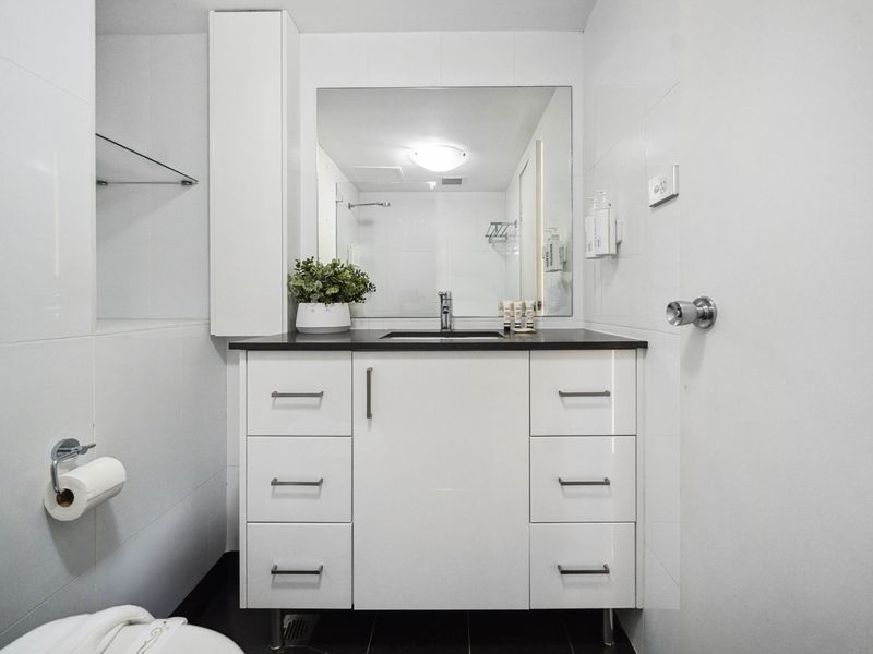 A well-lit space with modern fixtures to enhance your stay.