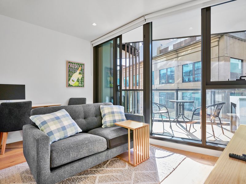 An open-plan living/dining space that seamlessly extends to a covered balcony