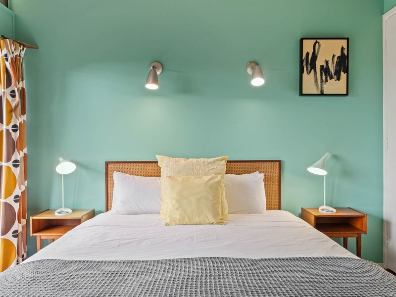 Bright and cozy bedroom with fresh, inviting linens.