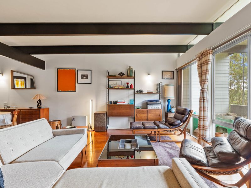 A mid-century modern living room with a cozy and inviting atmosphere. The perfect spot to unwind after a long day.