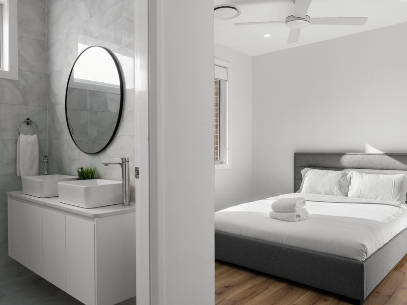 Bedroom View Featuring Bathroom Vanity and Mirror