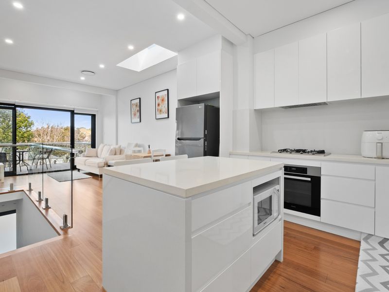 Step into contemporary elegance with this stunning open-plan kitchen and living area, perfect for entertaining.