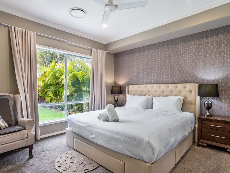 Naturally lit master bedroom with king sized bed