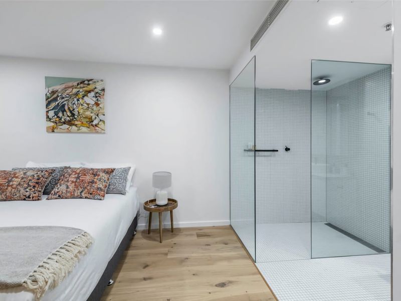 bed and bathroom separated by clean lines