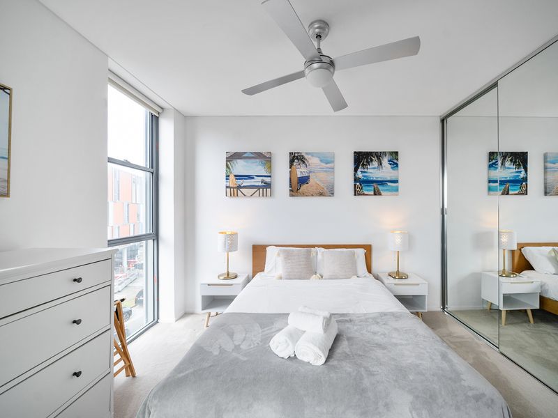 Bright bedroom with a queen bed and calming coastal feel.