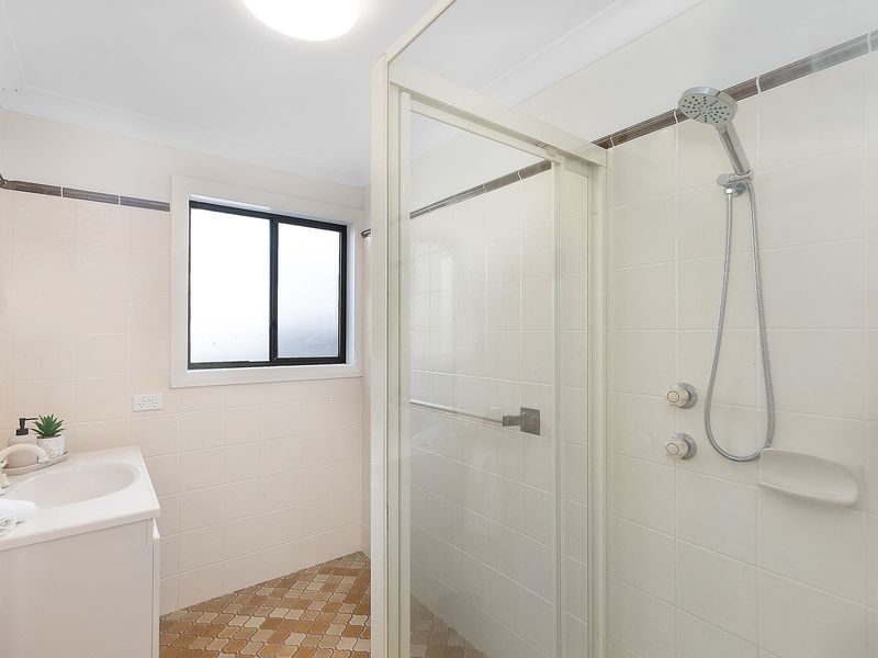 Downstairs bathroom with a clean, modern shower