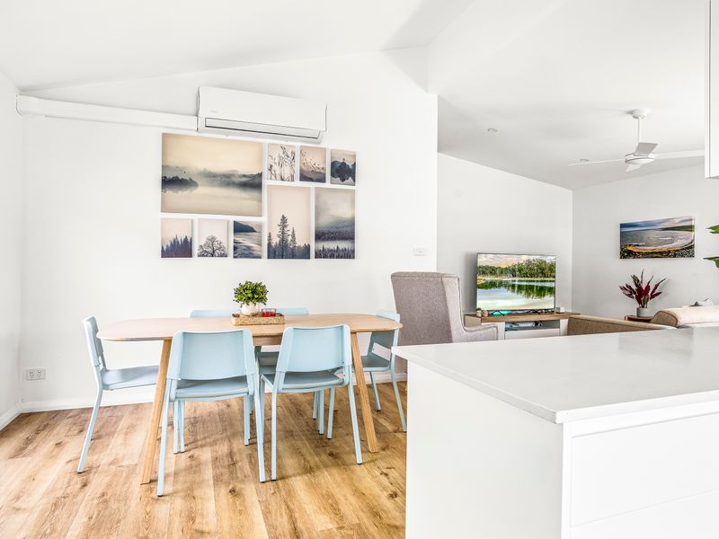 Bright dining area with natural light and coastal-inspired decor