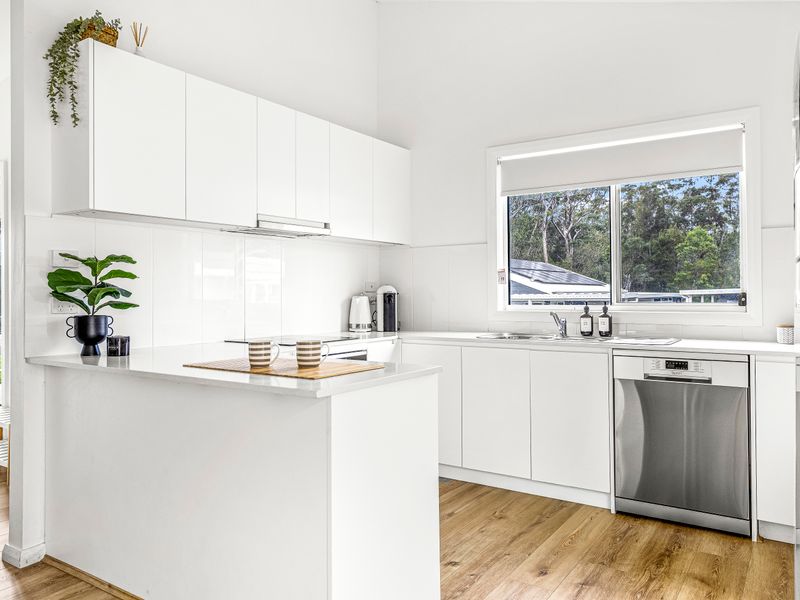 Modern kitchen with sleek white cabinets and stainless-steel appliances