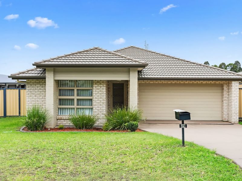 Street view of the home with private driveway access