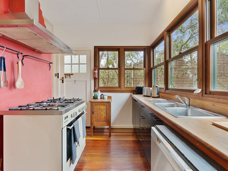 Well equipped kitchen with stovetop, fridge, and essentials.